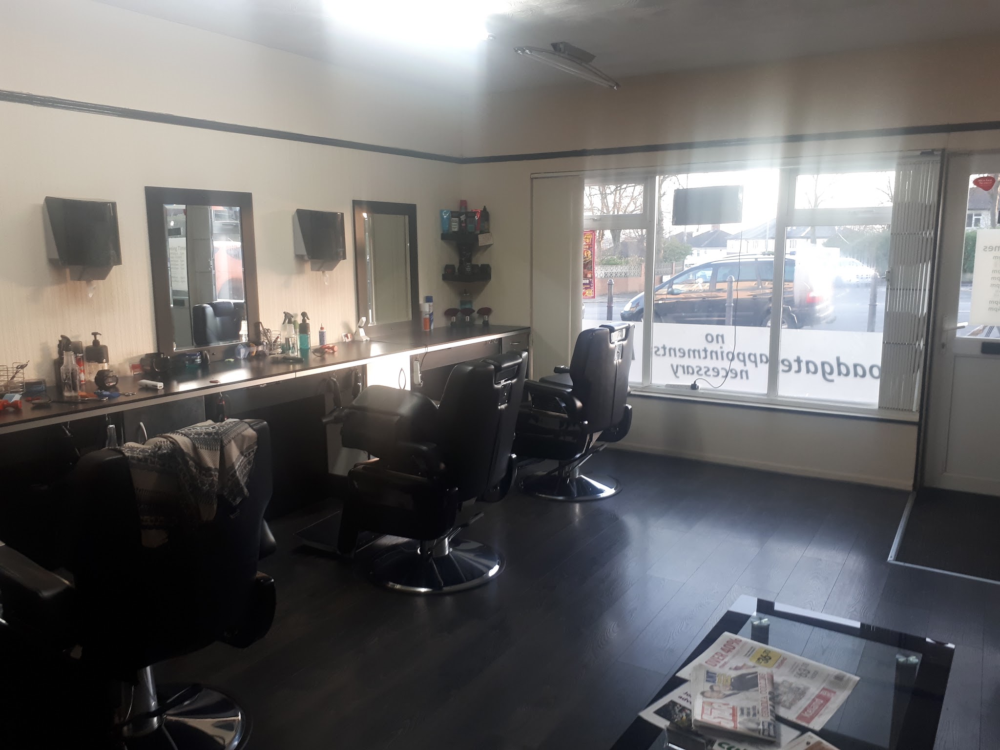 Broadgate's window and barber chairs beside Broadgate Lane